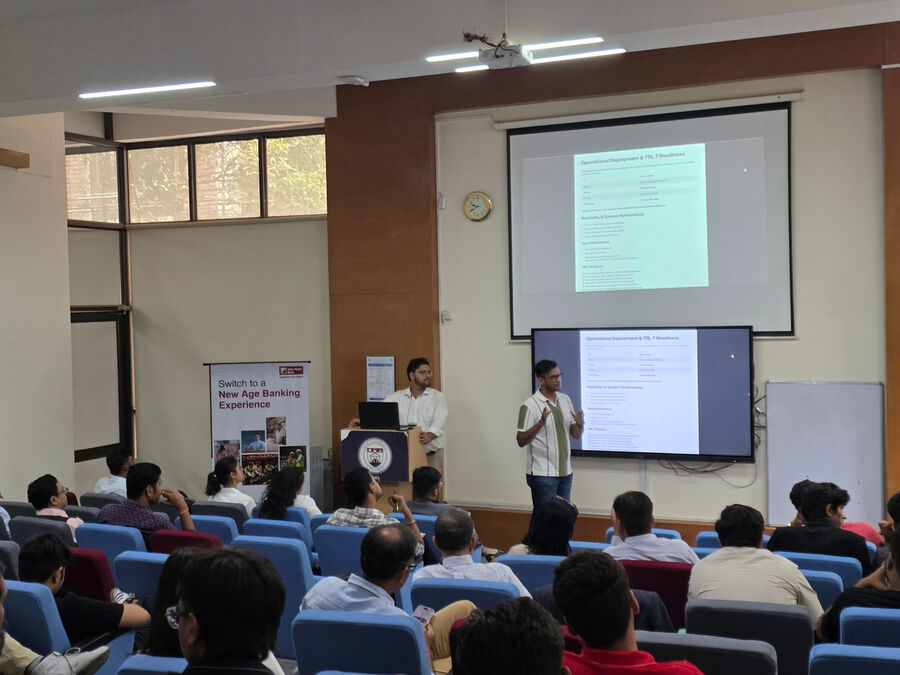 A speaker presents to a full lecture hall at The Conviction Table, IILM University